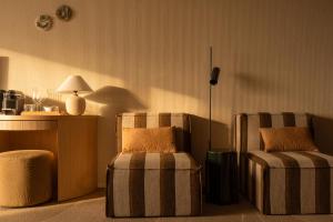 a living room with two chairs and a lamp at Elements Terschelling by Dutchen in Midsland