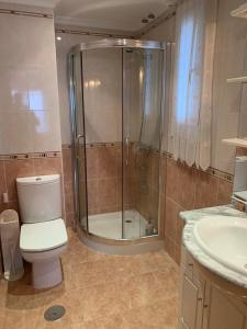 a bathroom with a shower and a toilet and a sink at Chalet unifamiliar Foz-Nois in Barrosa +16 photos
