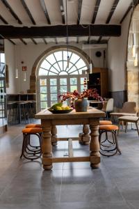 a table with a bowl of fruit on it in a room at EtxeAundi Hotel Boutique in Oñati