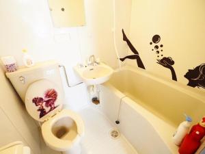 a bathroom with a toilet and a sink at Miyabi Stay Tokyo in Kamatachō