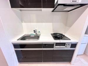 a small kitchen with a sink and a stove at Srs Kinshicho in Tokyo +46 photos