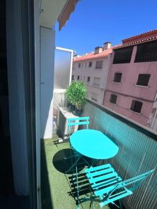 a blue table and chairs on a balcony with a table at Philoxenia in Bandol +2 photos