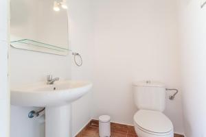 a white bathroom with a sink and a toilet at Ático en Candelaria 1 in Candelaria +17 photos