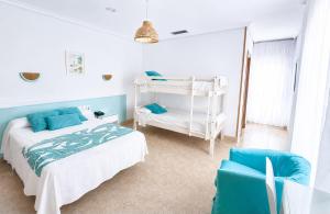 a bedroom with a bed and a bunk bed at Hotel Blanca Brisa Cabo de Gata in El Cabo de Gata