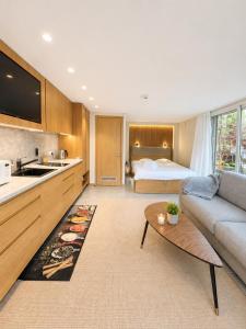 a living room with a bed and a couch and a table at Sodyba prie jūros in Palanga
