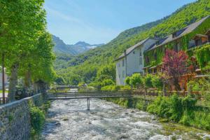 a river in a village with houses and trees at Chalet à Aulus-Les-Bains in Aulus-les-Bains +12 photos