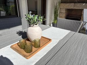 a white vase sitting on a table with three candles at Ferienwohnung Ottenzeller Haisl in Arrach