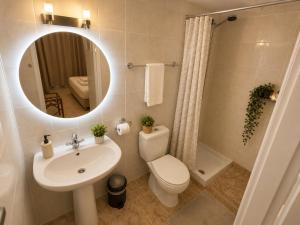 a bathroom with a sink and a toilet and a mirror at Atlantis Hotel in Agios Nikolaos +71 photos