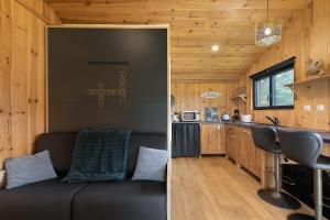 a living room and kitchen in a tiny house at Ma cabane Océan in Le Verdon-sur-Mer +16 photos