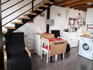 a kitchen with a table and a washing machine at Gite Belle vue in Semur-en-Brionnais