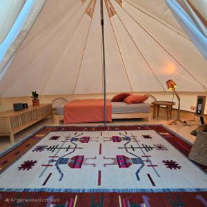 a room with a tent with a bed and a rug at Amurg Glamping&Pool in Vadu +14 photos