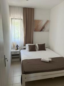 a bedroom with a bed and a window at Apartman Magdalena in Budva