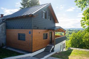 a house with a metal roof at Luni Stay - Jacuzzi, Sauna & Nature Escape in Jastrebarsko