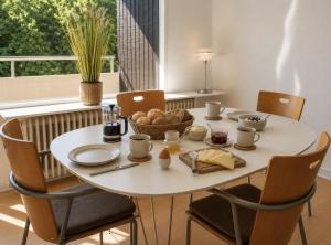 a white table with a bowl of food on it at Stor 2 værelses lejlighed in Randers