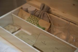 a box with a wine glass and other items in it at Langhem Suites Luxury Apartments in Castiglione Falletto