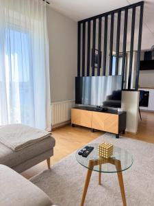 a living room with a tv and a coffee table at River Apartment in Pärnu