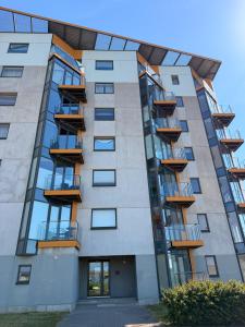 an apartment building with balconies on it at River Apartment in Pärnu