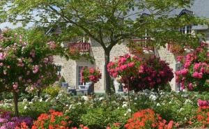 a garden of flowers in front of a house at Hostellerie de la Motte jean in Saint-Coulomb