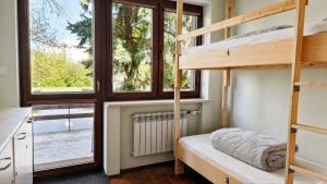 a bedroom with bunk beds and a window at For rest Hostel in Lublin