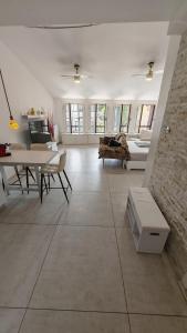 a large white living room with tables and a couch at Sole del Garda Haus in Desenzano del Garda