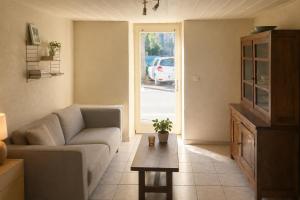 a living room with a couch and a table at Charmant T2 en RDC au centre de Figeac in Figeac