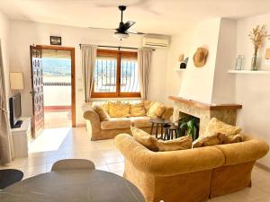 a living room with a couch and a fireplace at Amor Supremo in Cumbre del Sol
