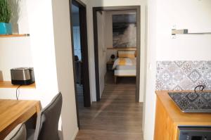 a hallway leading to a bedroom with a bed at Ferienwohnungen Leber in Bad Neustadt an der Saale