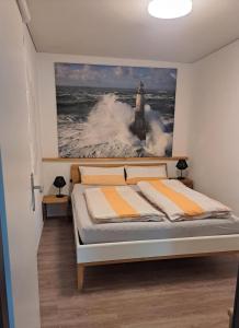 a bedroom with a bed with a picture of a lighthouse at Ferienwohnungen Leber in Bad Neustadt an der Saale