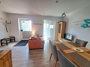 a living room with a couch and a table at Ferienwohnungen Leber in Bad Neustadt an der Saale