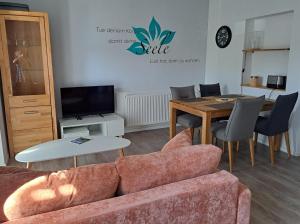 a living room with a couch and a table at Ferienwohnungen Leber in Bad Neustadt an der Saale