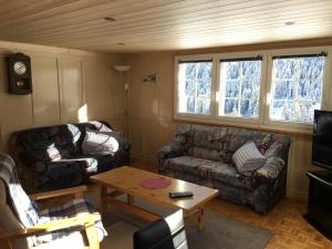 a living room with a couch and a coffee table at Casa Gion Giusep in Sedrun