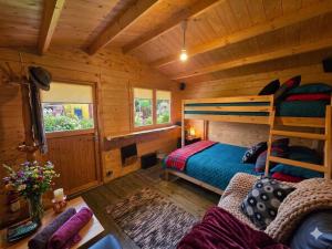 a log cabin bedroom with a bunk bed and a couch at Cozy Summer House with Free Parking near Town Center & Beach in Kuressaare