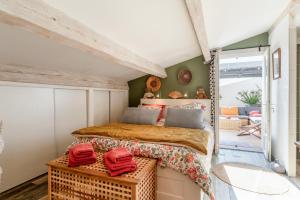 a bedroom with a bed and a door to a patio at Mon Cabanon Roquemaure in Roquemaure +19 photos