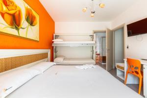 a bedroom with two beds and an orange wall at B&B Acquamarina in Gallipoli +15 photos