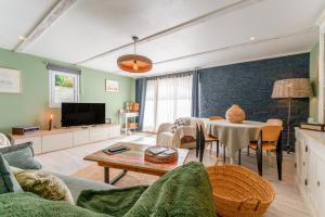 a living room with a couch and a table at Mon Cabanon Roquemaure in Roquemaure