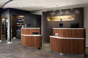 a lobby with a hair salon with wooden counters at Courtyard by Marriott Valdosta in Valdosta +26 photos