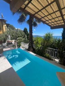 a swimming pool in a villa with a view at Villa Samanta in Gardone Riviera