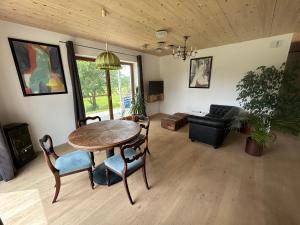 a living room with a table and chairs and a couch at Beim Baltas in Wildpoldsried +72 photos