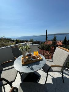 a tray of food on a table on a patio at Vila Peričić in Dramalj