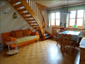 a living room with a couch and a table at Schwarz-Hof in Honnersreuth