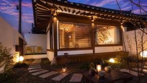 a house with a window and a table and lights at 한옥스테이 설화 in Gyeongju