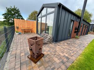 a black building with a patio with a wooden table at Fernblick- Sauna- WLAN- Haus 2 in Neheim-Hüsten +5 photos