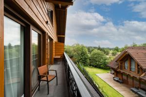 a balcony with a view of a house at TATRYSTAY Happy Nest Apartments in Tatranská Lomnica