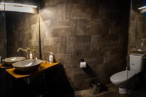 a bathroom with two sinks and a toilet at CASA HAIDUCILOR Green Codru in Codru +5 photos