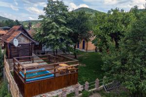 an aerial view of a log cabin with a yard at CASA HAIDUCILOR Green Codru in Codru