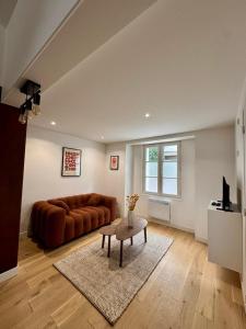 a living room with a couch and a table at Maison Delayant in La Rochelle