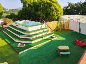 a set of stairs leading to a pool with a playground at La Fiesta House in Capaccio-Paestum