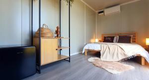 a bedroom with a bed and a flat screen tv at Free People Bungalow & Cort in Vama Veche