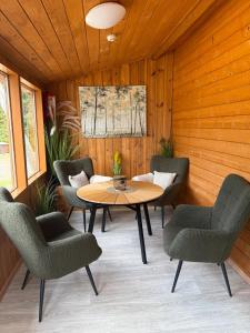 a patio with a table and chairs in a room at Guest house Elernes Muiža in Daugavpils