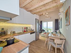 a kitchen and dining room with a table and chairs at Gaea Loft Villa - 1st Floor in Kokkini Khanion